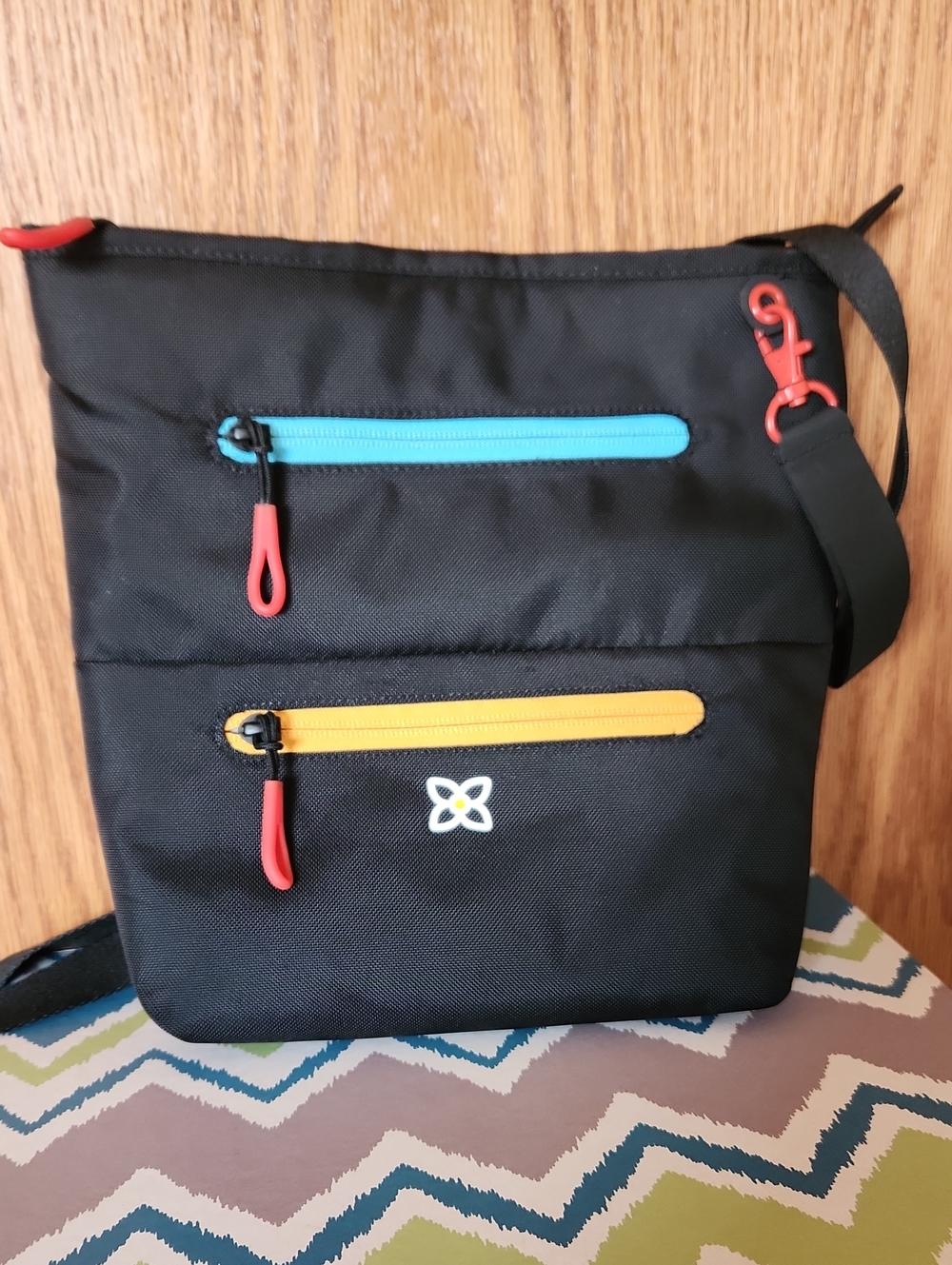 Sherpani Black Crossbody with Blue and Yellow Zipper Accents and Red Pulls